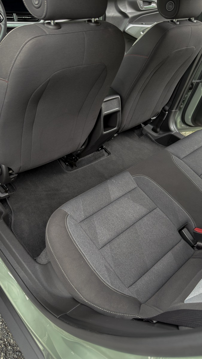 After: the same rear footwell vacuumed clean with seats wiped down