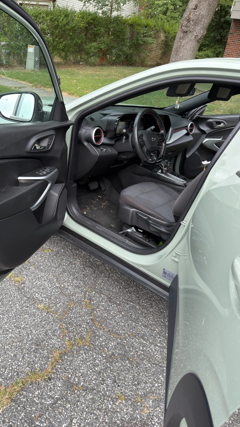 Before: Chevrolet Trax driver footwell and door sill with dirt and debris