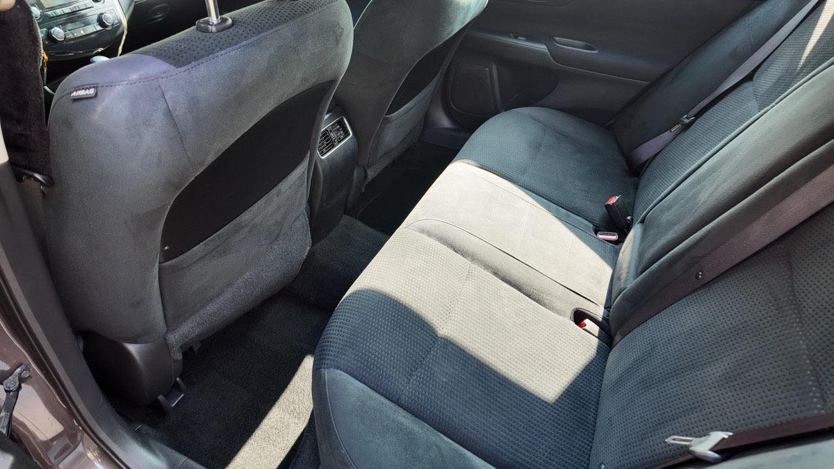 Deep-cleaned rear bench seats and carpets in a Nissan sedan