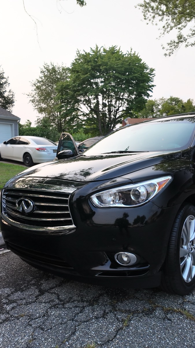 Black Infiniti QX60 washed and dried in the driveway